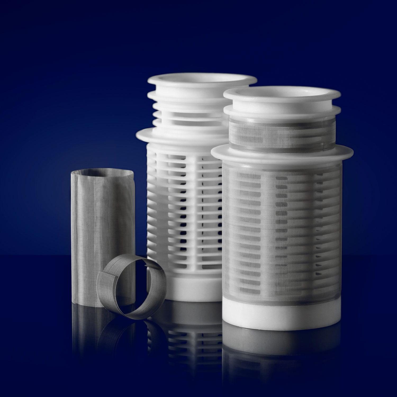 Plastic and stainless steel mesh filters on a navy backdrop