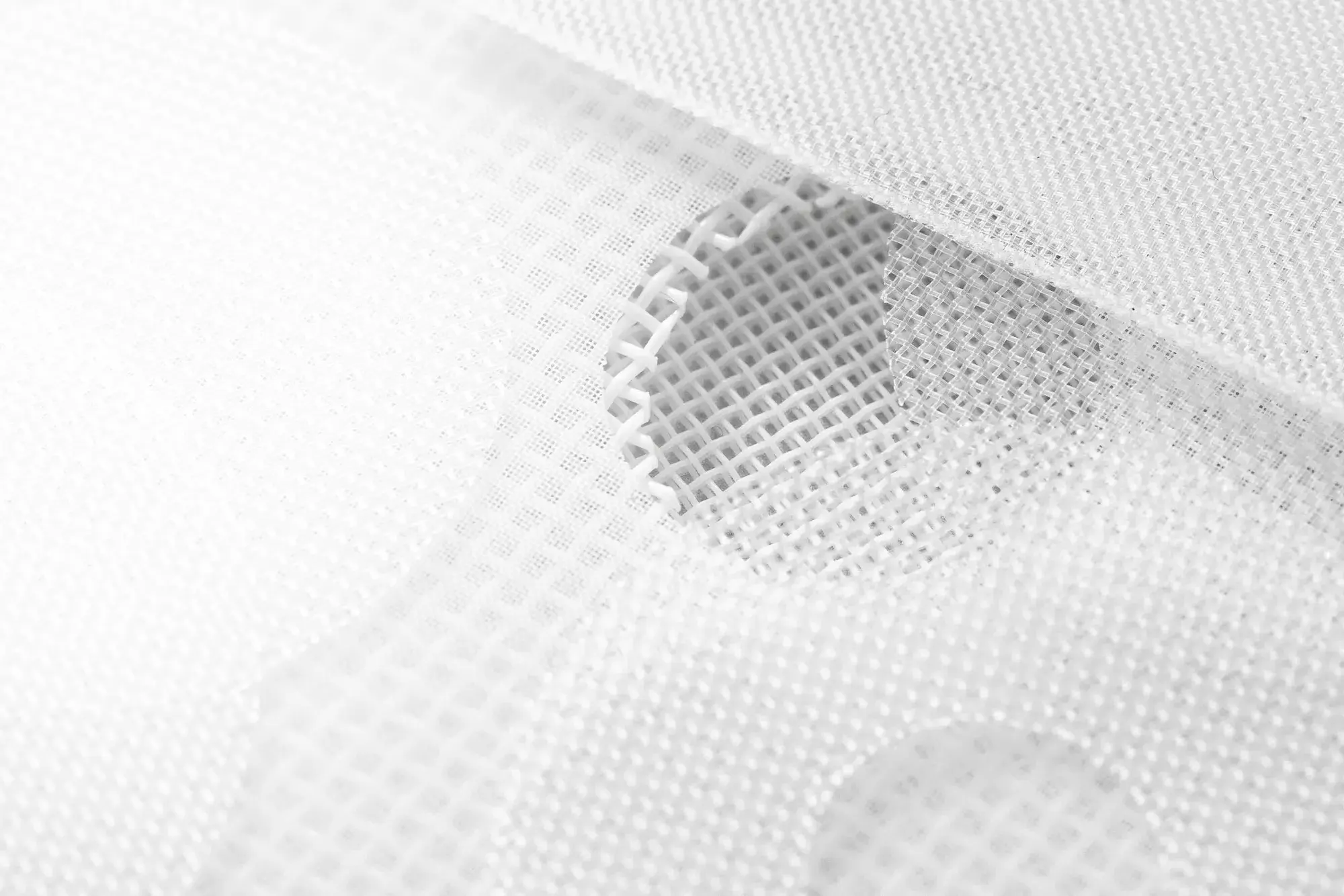 Close-up of white plastic mesh filter material